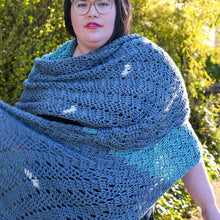 Load image into Gallery viewer, A woman wears a hand-crocheted shawl featuring chevron lace and a row of ruffles down the center back
